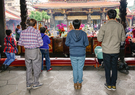TAIPEI, TAIWAN - JAN 5, 2016. Local people praying at Longshan Temple in Taipei, Taiwan. The temple served as a place of worship and a gathering place for the Chinese settlers.のeditorial素材