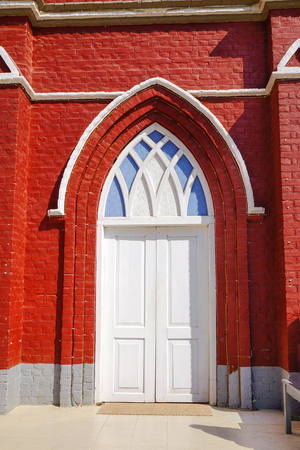 White wooden door at the old church in Pyin Oo Lwin, Myanmar. The small town of Pyin Oo Lwin is a reminder of the British colonial times in Myanmar.の写真素材