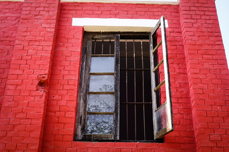 Red brick wall with glass window at the old colonial house in Pyin Oo Lwin, Myanmar. The small town of Pyin Oo Lwin is a reminder of the British colonial times in Myanmar.の写真素材