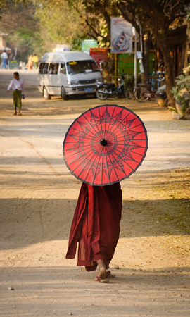 Bagan, Myanmar - Feb 17, 2016. Little Buddhist monk walking on street in Bagan, Myanmar. Bagan is home to the largest and densest concentration of Buddhist temples.のeditorial素材