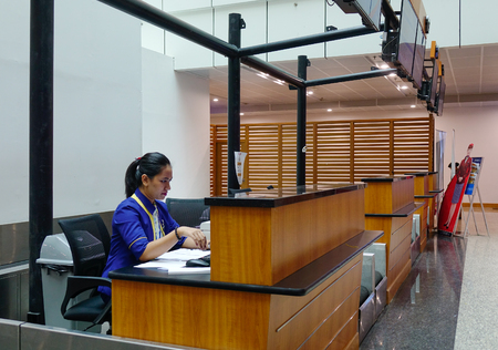 Yangon, Myanmar - Feb 14, 2017. A staff working at Departure Hall of Yangon Airport in Myanmar. Yangon Airport is the primary and busiest international airport of Myanmar.のeditorial素材