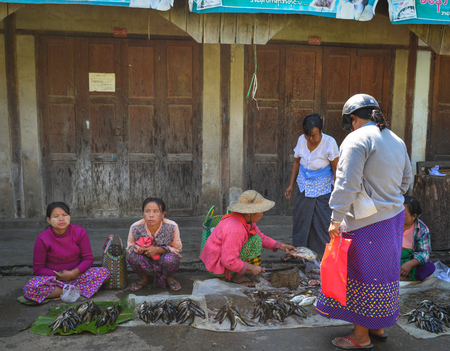 Nyaungshwe, Myanmar - Feb 6, 2017. Vendors at the local market in Nyaungshwe, Myanmar. Nyaungshwe is the tourist hub for visiting Inlay Lake Wetland Sanctuary.のeditorial素材