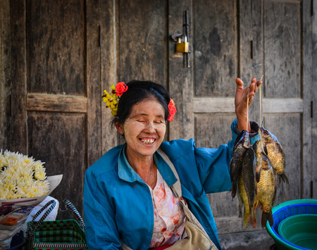 Nyaungshwe, Myanmar - Feb 6, 2017. Portrait of vendor at market in Nyaungshwe, Myanmar. Nyaungshwe is the tourist hub for visiting Inlay Lake Wetland Sanctuary.のeditorial素材