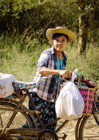 Bagan, Myanmar - Feb 4, 2017. Portrait of Burmese vendor with bicycle in Bagan, Myanmar. Bagan in central Burma is one of the world greatest archeological sites.のeditorial素材