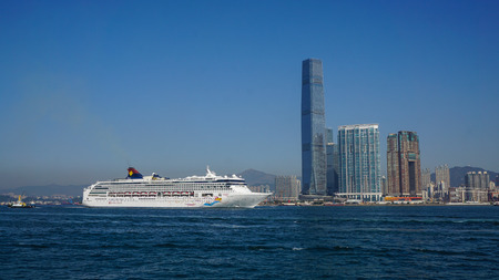 Hong Kong - Dec 30, 2014. Cruise liner at Kowloon pier with cityscape background in Hong Kong, China. Hong Kong is the most popular city for tourists.のeditorial素材