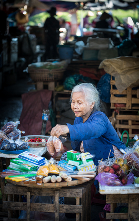 Hoi An, Vietnam - Dec 1, 2015. An old woman at local market in Hoi An Ancient Town, Vietnam. Hoi An is Vietnam most atmospheric and delightful town.のeditorial素材