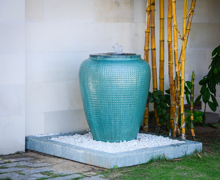Asian traditional water container for decoration with bamboo trees at the luxury resort gardenの写真素材