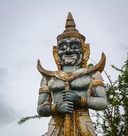 An Evil God statue under gray sky at Khmer Buddhist temple in An Giang, Vietnam. An Giang is...