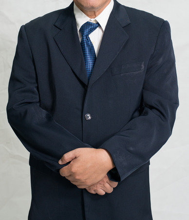 Senior businessman in suit at studio. Holding hand. Close up.の写真素材