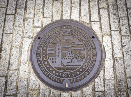 Yokohama, Japan - Nov 5, 2014. Manhole drain cover on the street in Yokohama, Japan. Yokohama is...