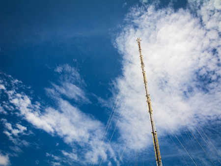 Telecome tower under blue sky with clouds at sunny dayの写真素材