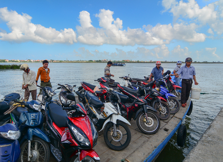 Hoi An, Vietnam - Dec 3, 2015. Wooden ferry carrying motorbikes on river in Hoi An, Vietnam. Ancient and peaceful, Hoi An is one of the most popular destinations in Vietnam.のeditorial素材