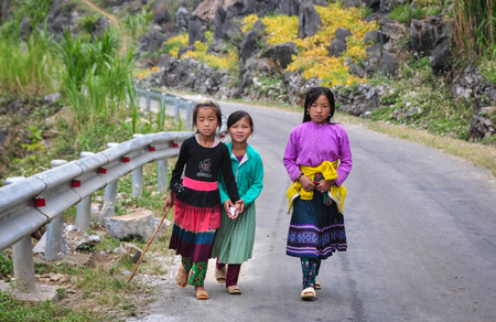Ha Giang, Vietnam - Oct 14, 2014. Ethnic children on mountain road in Ha Giang province, Vietnam. Ha Giang has many festivals due to the presence of more than 20 ethnic minority groups.のeditorial素材