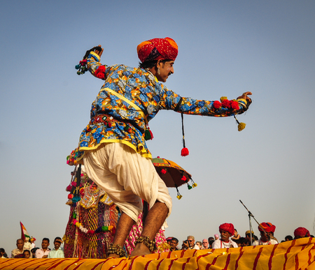 PUSHKAR, INDIA - MAR 7, 2012. Rajasthani folk dancers in colorful ethnic attire perform in Pushkar, India. Pushkar is one of the most ancient cities of India.のeditorial素材