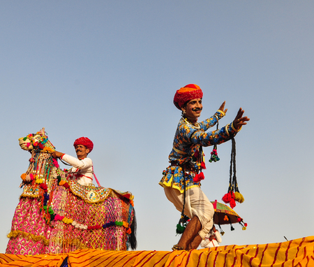 PUSHKAR, INDIA - MAR 7, 2012. Rajasthani folk dancers in colorful ethnic attire perform in Pushkar, India. Pushkar is known around the world for its Pushkar Camel Fair.のeditorial素材