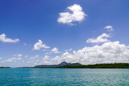 Landscape of green island with clear sky and mountain background at sunny dayの写真素材