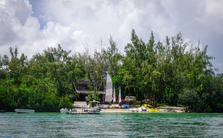 Flacq, Mauritius - Jan 12, 2017. Sailing boats on the green island at sunny day in Ile aux Cerfs, Mauritius. Mauritius enjoys a tropical climate with clear warm sea waters and beaches.のeditorial素材