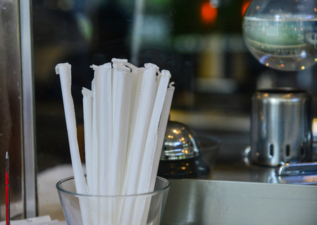 White straws in glass at the kitchen of coffee shop. Close up.の写真素材