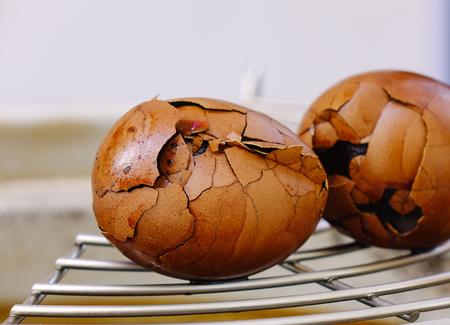 Chinese eggs boiled with tea and spices. Isolated and closed up.