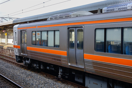 Tokyo, Japan - Dec 25, 2015. A JR train stopping at Kunitachi Station in Tokyo, Japan. Railways are...