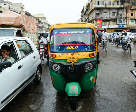 Jaipur, India - Jul 27, 2015. Tuk-tuk taxi on street with old buildings at downtown in Jaipur, India. Jaipur, known as the Pink city, is a major tourist destination in India.のeditorial素材