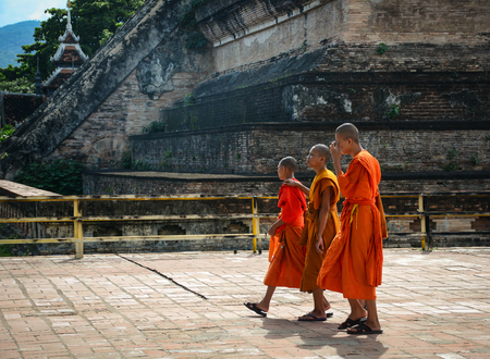 Chiang Mai, Thailand - Jun 22, 2016. Buddhist monks walk at Wat Chedi Luang in Chiang Mai, Thailand. Wat Chedi Luang hosts monk chats every day - tourists are invited to speak with monks.のeditorial素材