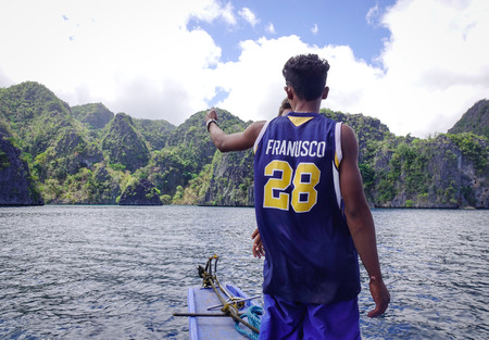 Coron, Philippines - Apr 9, 2017. Local men standing on wooden boat in Coron Island, Philippines. Coron has been described as one of the best spots in the World for Wreck diving.のeditorial素材