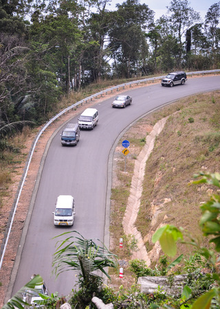 Kampot, Cambodia - Jan 25, 2012. Mountain road with vehicles in Kampot, Cambodia. Kampot is a small town (pop. 40,000) in south-east Cambodia and capital of the province with same name.のeditorial素材