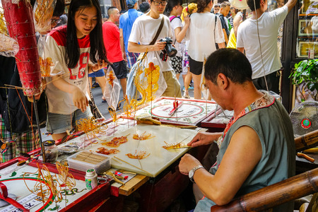 Chengdu, China - Aug 20, 2016. People sell souvenirs at Jinli Ancient Street in Chengdu, Sichuan, China. Jinli Street is a major tourist attraction and travel spot in Chengdu.のeditorial素材