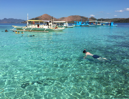 Coron, Philippines - Apr 9, 2017. People swimming on the blue sea at sunny day in Coron, Philippines. Coron Island is the 3rd largest island in Calamian Group of Islands in Palawan.のeditorial素材