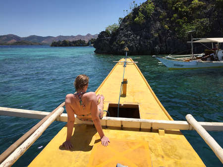 Coron, Philippines - Apr 9, 2017. A woman relaxing on boat in Coron, Philippines. Coron is dream destinations for scuba diving, island hopping, kayaking and snorkeling.のeditorial素材