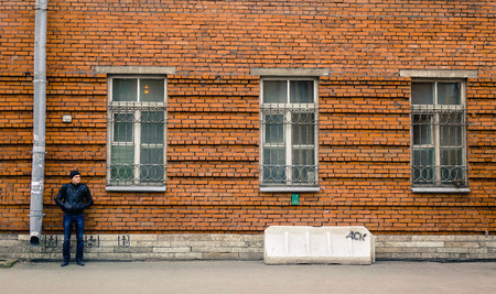 Saint Petersburg, Russia - Oct 10, 2016. A young man standing on street at downtown in Saint Petersburg, Russia. Much of St. Petersburg architecture is Baroque and neoclassical.のeditorial素材