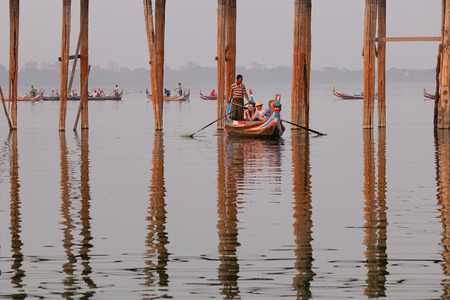 Mandalay, Myanmar - Feb 20, 2016. Wooden boats on lake at sunrise in Mandalay, Myanmar. Mandalay is the second-largest city and the last royal capital of Myanmar.のeditorial素材