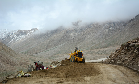 Ladakh, India - Jul 18, 2015. A road-roller working on mountain road in Leh, Ladakh, India. Ladakh is the highest plateau in the state of Jammu & Kashmir with much of it being over 3,000m.のeditorial素材