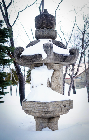 Stone lantern at Japanese garden in the winter. Close up.の写真素材