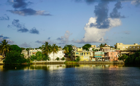 Mahebourg, Mauritius - Jan 5, 2017. River scene with a small village at sunset in Mahebourg, Mauritius. Mahebourg is a small city on the south-eastern coast of Mauritius.のeditorial素材