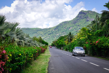 Le Morne, Mauritius - Jan 5, 2017. Cars running on rural road in Le Morne, Mauritius. Mauritius was uninhabited until 1598, and had much unique wildlife and plant life.のeditorial素材