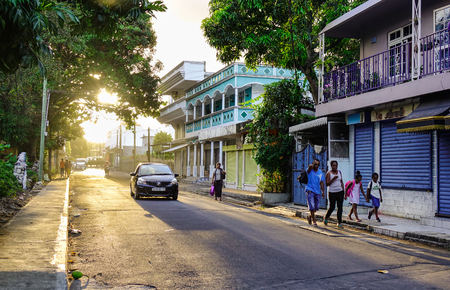 Mahebourg, Mauritius - Jan 5, 2017. People walking on street at sunset in Mahebourg, Mauritius. Mahebourg is a small city on the south-eastern coast of Mauritius.のeditorial素材