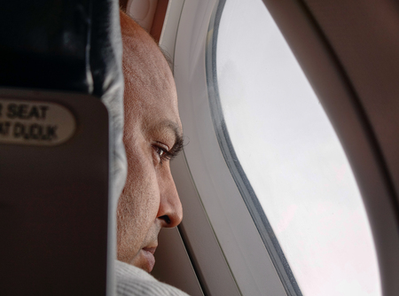 Kuala Lumpur, Malaysia - Dec 16, 2015. A man sitting inside an airplane in Kuala Lumpur, Malaysia.のeditorial素材