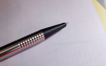 Ball-point pen on the white paper. Close up.の写真素材