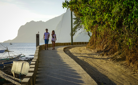 Palawan, Philippines - Apr 5, 2017. A couple walking on rural road at El Nido Township in Palawan, Philippines. Palawan is one of the most beautiful islands in the world.のeditorial素材