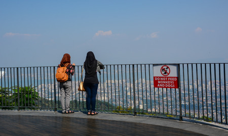 Penang, Malaysia - Mar 11, 2016. People standing on observation deck at Penang Hill in Malaysia. Penang Hill is a hill resort comprising a group of peaks on Penang Island.のeditorial素材