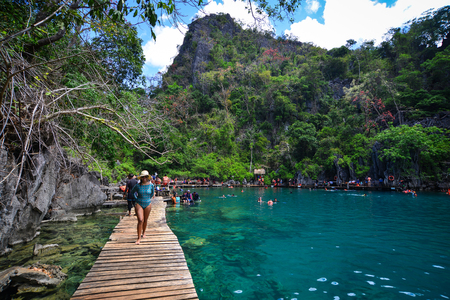 Coron, Philippines - Apr 9, 2017. People walking on wooden bridge at Barracuda Lake in Coron, Philippines. Barracuda is one of the most unusual, amazing and wired dive-sites of the Philippines.のeditorial素材