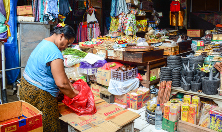 Bali, Indonesia - Apr 21, 2016. A woman selling goods at Central Market in Bali, Indonesia. Bali is a popular tourist destination, which has seen a significant rise in tourists.のeditorial素材