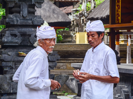 Bali, Indonesia - Apr 21, 2016. Burmese men praying at Hindu temple in Bali, Indonesia. Bali is a popular tourist destination, which has seen a significant rise in tourists.のeditorial素材