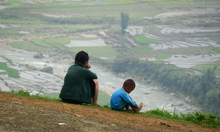 Sapa, Vietnam - May 30, 2016. A woman with her son sit on the hill in Sapa, Vietnam. Sapa is a beautiful, mountainous town in northern Vietnam along the border with China.のeditorial素材