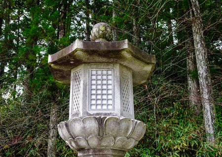 A stone lantern at forest in Mount Koya, Japan. Mt. Koya is primarily known as the world headquarters of the Shingon sect of Japanese Buddhism.の写真素材