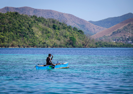 Palawan, Philippines - Apr 11, 2017. A local man with small boat on the sea at El Nido Township in Palawan, Philippines. The Palawan coast is one of the most unspoilt places in the world.のeditorial素材
