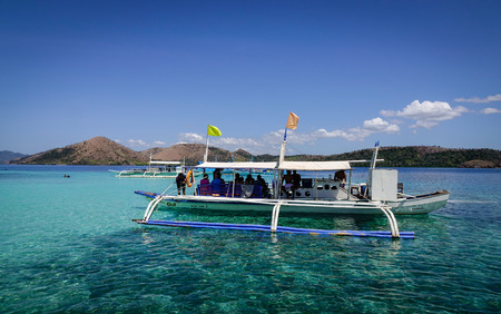 Palawan, Philippines - Apr 11, 2017. A wooden boat carrying tourists on the sea in Palawan, Philippines. The Palawan coast is one of the most unspoilt places in the world.のeditorial素材