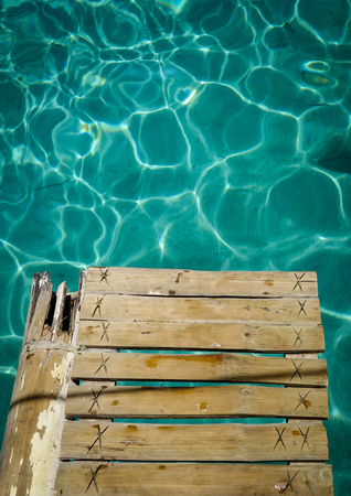 Wooden bridge with turquoise water on the sea in summer.の写真素材
